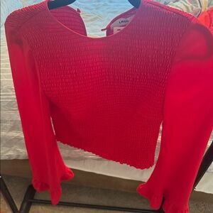Likely red top. Bought at a boutique still has tags.